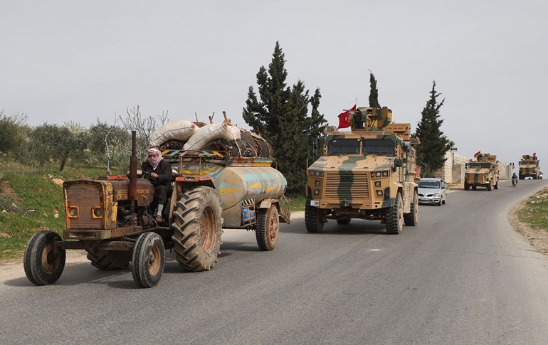 Turkish military vehicles drive along a road near the town of Ariha in Syria's northwestern Idlib province, April 5, 2020. Photo: Aaref Watad / AFP 