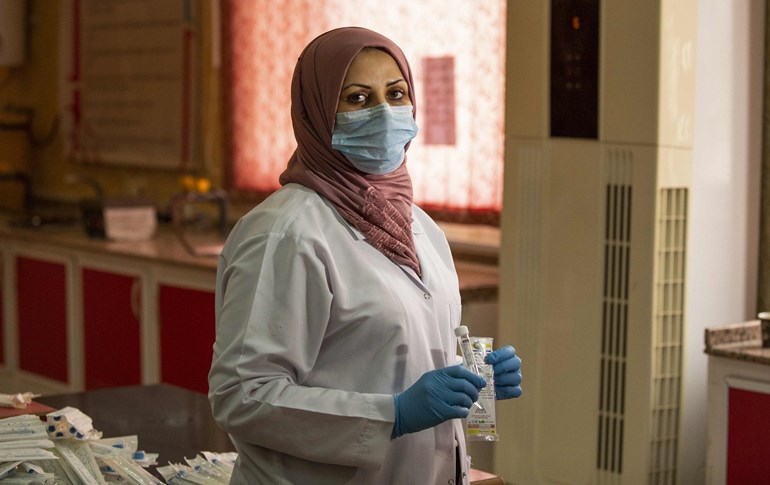 A member of the COVID-19 Crisis Cell at Basra university on April 6, 2020. Photo: Hussein Faleh/AFP