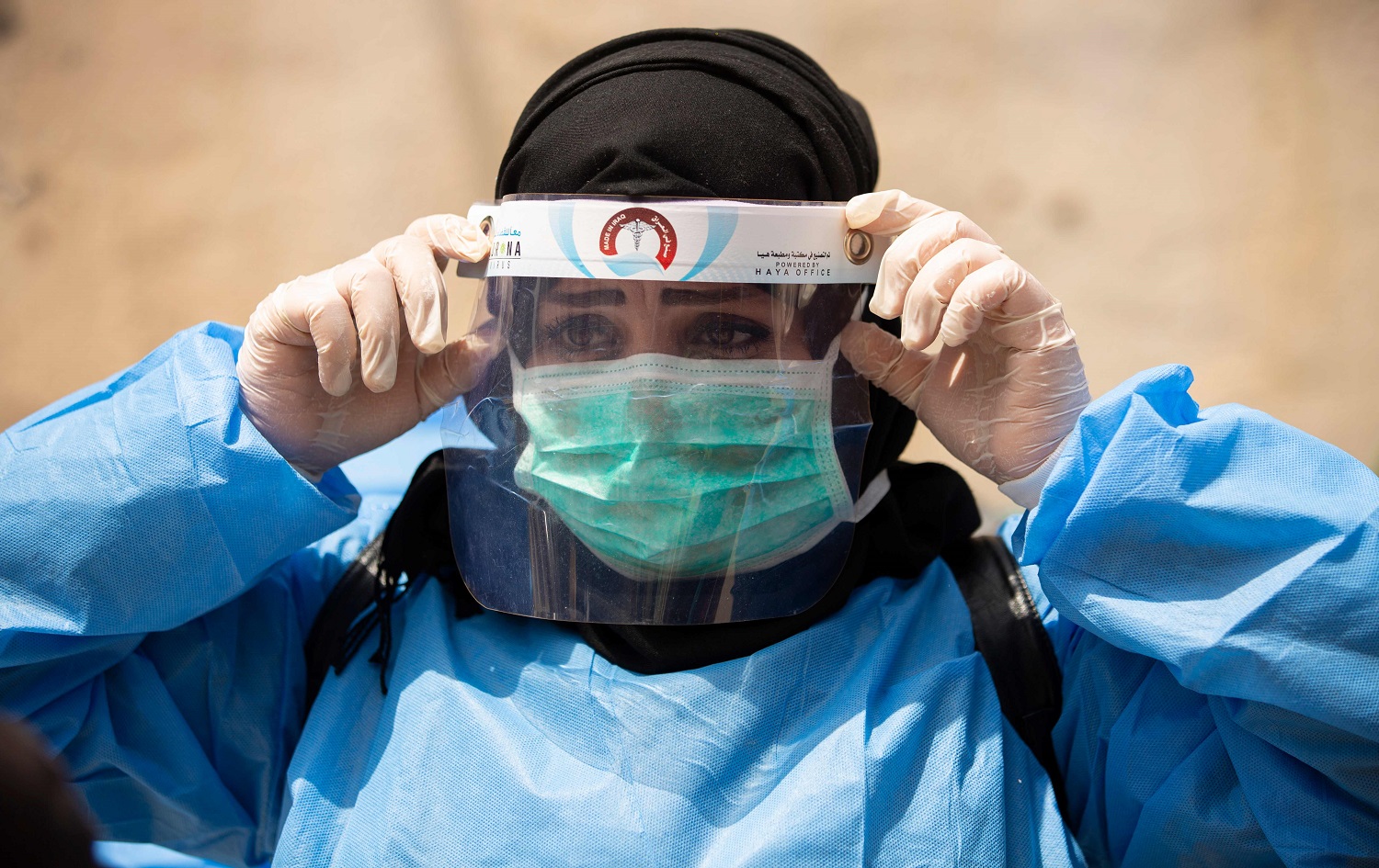  A medical worker adjusts her protective headgear in Basra on June 2, 2020. Photo: Hussein Faleh/AFP