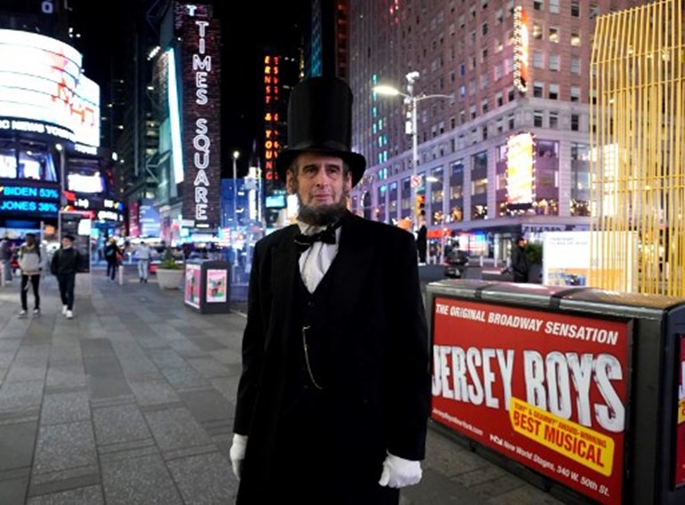 A man dressed as Abraham Lincoln comes out to watch election results in Times Square in New York on November 3, 2020. TIMOTHY A. CLARY / AFP