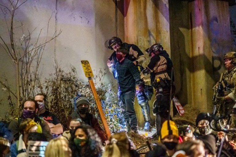 Minneapolis State Patrol arrest journalists and people protesting against racism and issues with the presidential election after they blocked interstate 94 in Minneapolis, Minnesota on November 4, 2020. Protestors and journalists were released later in the night. Photo: Kerem Yucel / AFP