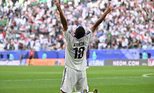 أيمن حسين محتفلاً بعد تسجيله الهدف الثاني في مرمى اليابان/ AFP
