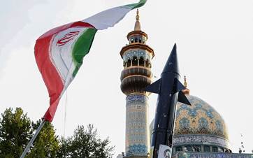 Iranians lift up a flag and the mock-up of a missile during a celebration following Iran's missiles and drones attack on Israel at Palestine Square in central Tehran, on April 15, 2024. Photo: ATTA KENARE / AFP