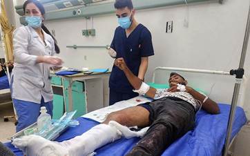 A handout picture released by the official Syrian Arab News Agency (SANA) on May 29, 2024 shows an injured man receiving medical care at a hospital in the coastal city of Baniyas, following what Syria's defence ministry said was an Israeli air strike. Photo: SANA/AFP