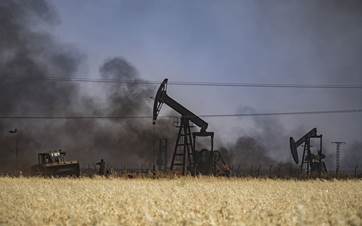 Smoke bellows from an oil well in al Qahtaniyah, northeastern Syria. File photo: AFP