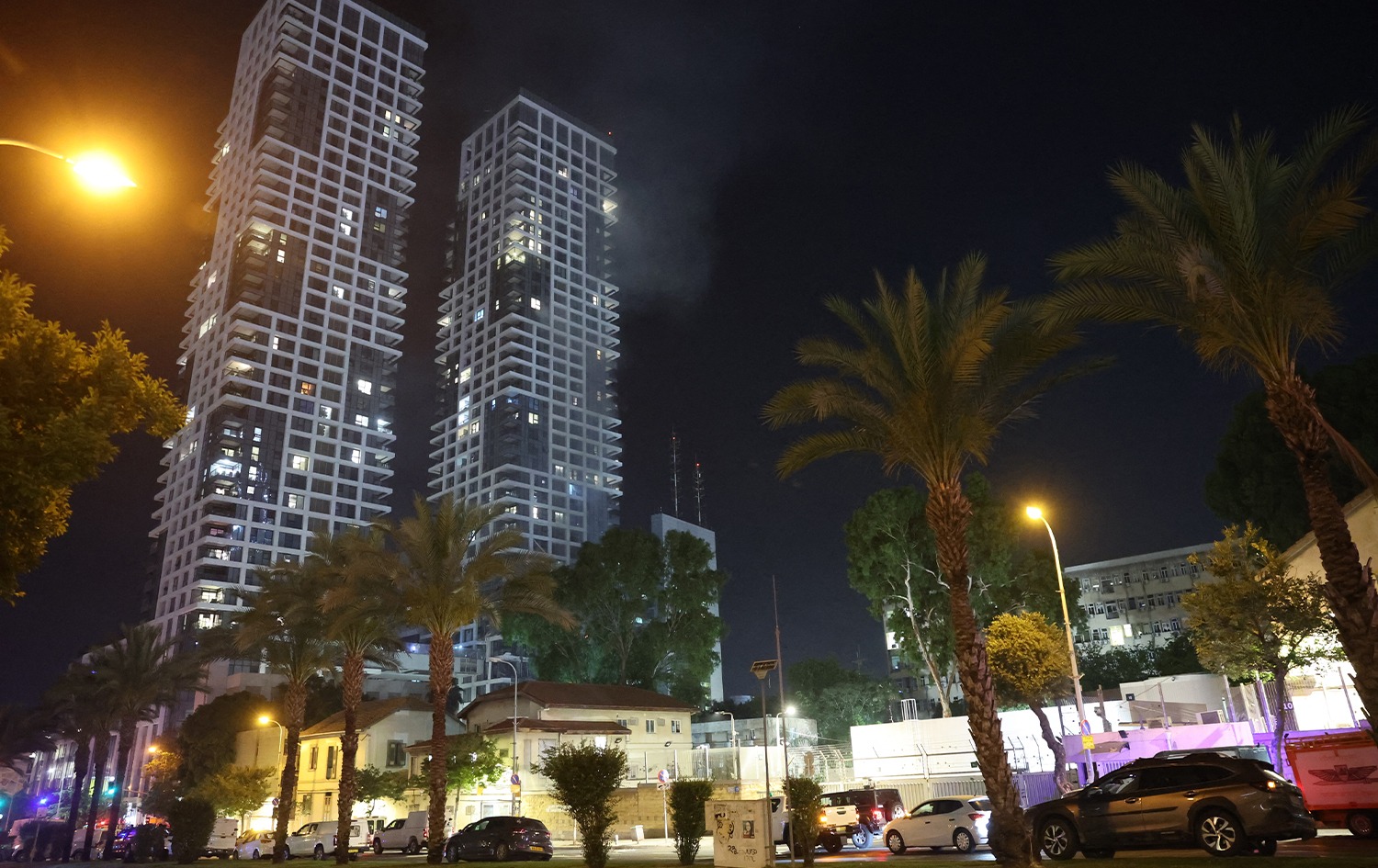 Smoke rises from a building, reportedly hit by a missile fired from Iran, in central Tel Aviv on June 13, 2025. Photo: AFP