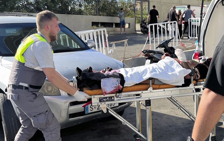 A first-responder carries a wounded man at al-Zahraa Hospital in Beirut, Lebanon, on September 17, 2024. Photo: AP/Hussein Malla