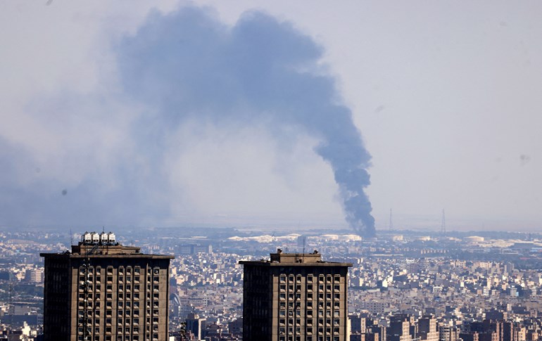 Smoke billows in the distance from an oil refinery following an Israeli strike on the Iranian capital Tehran on June 17, 2025. Photo: AFP