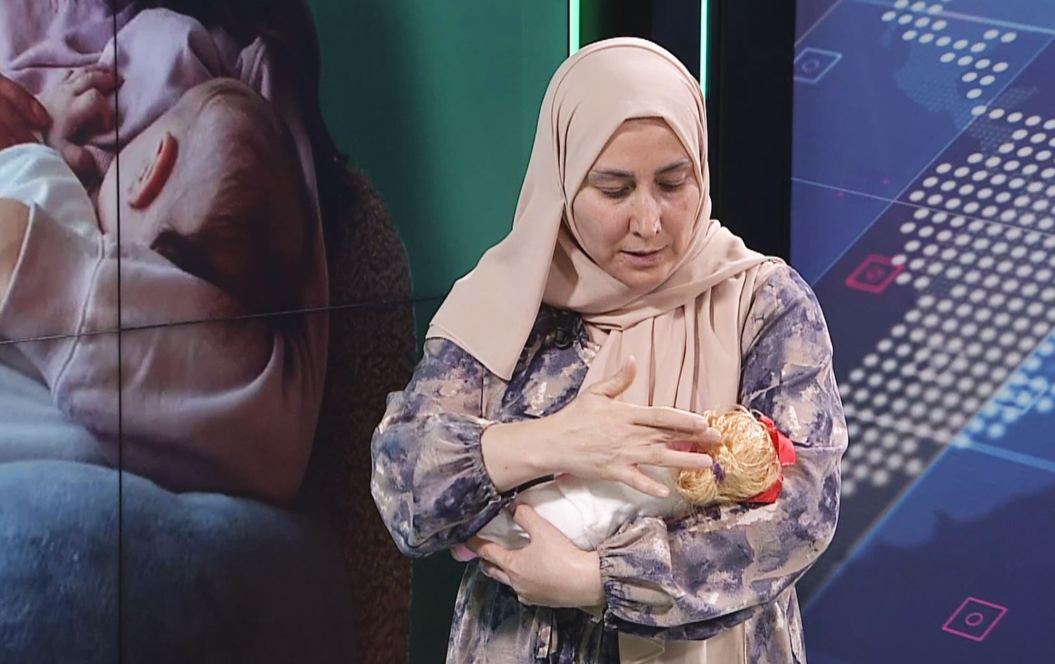 پەرستارێک لەنێو ستۆدیۆ رێگەی دروستی شیردانی سرووشتی روون دەکاتەوە