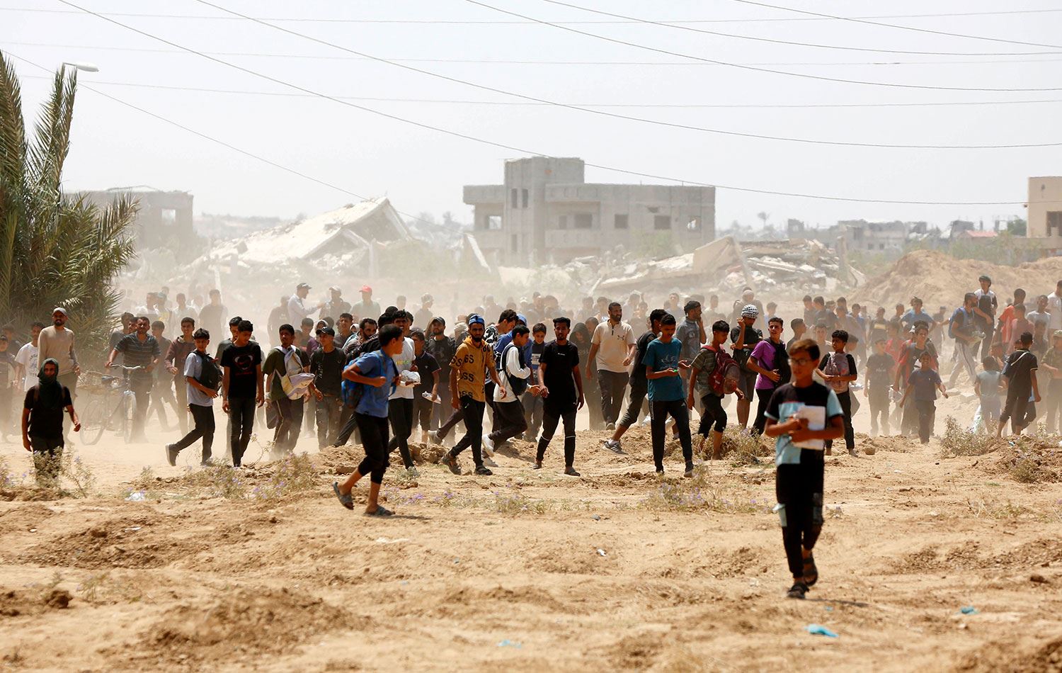 İsrail'in saldırısı ve ambargosu altındaki Gazze Şeridi'ne havadan paraşütle insani yardım malzemesi indiriyor. Filistinliler, yardım almak için birbirleriyle yarışıyor. / Foto: AA