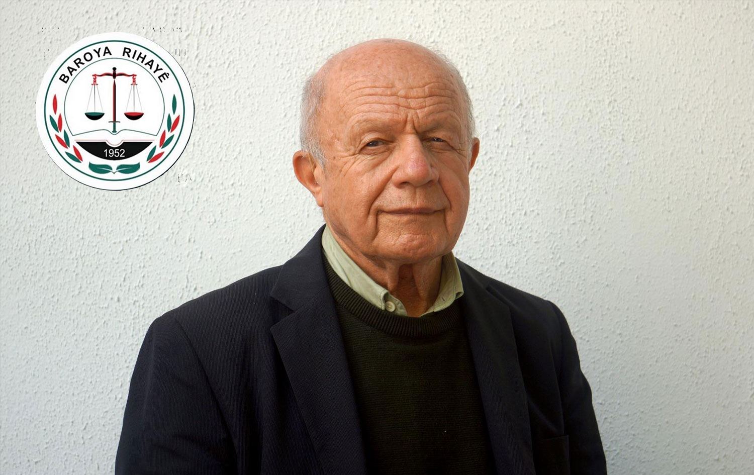 Îsmaîl Beşîkçî û logoya Baroya Rihayê /Wêne: Rûdaw Grafîk