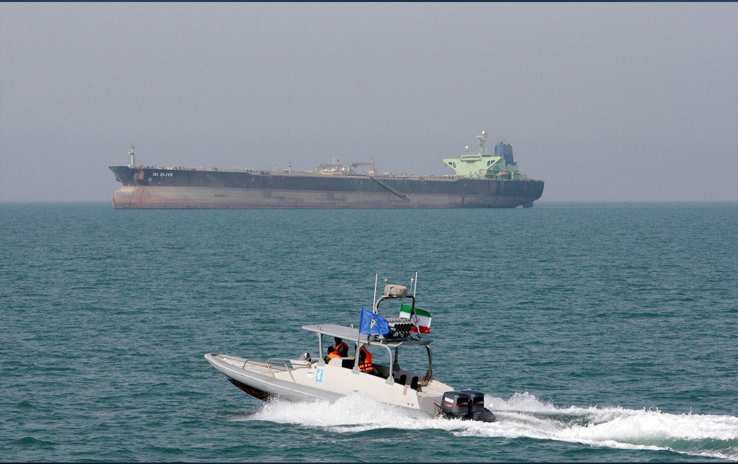 An Islamic Revolutionary Guard Corps (IRGC) speedboat moves in the Persian Gulf while an oil tanker is seen in the background. Photo: Vahid Salemi/AP
