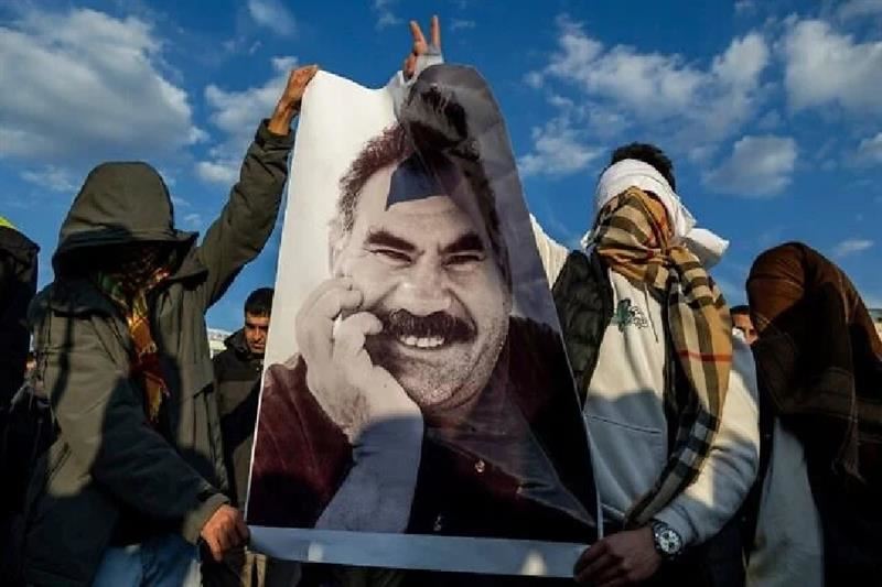 Youngsters hold a photograph of Abdullah Ocalan as they gather to watch live on a tv screen a Pro-Kurdish Peoples' Equality and Democracy Party, or DEM, delegation members releasing an statement from Ocalan, in Diyarbakir, Turkey. AP file photo