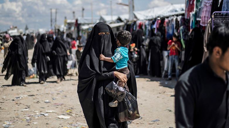 AFP file photo of a woman carries a toddler in al-Hol camp.