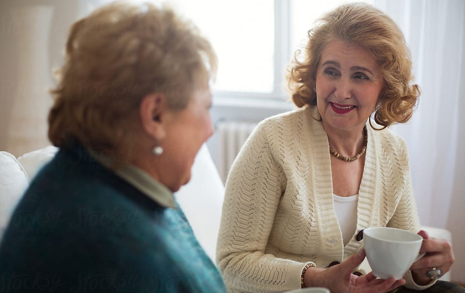 دوو خانمی بەساڵاچوو کووپی چایان بەدەستەوەیە.