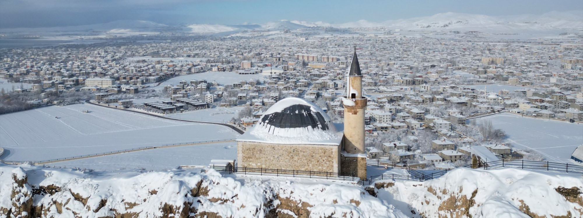 An aerial view shows historic structures covered in white following heavy snowfall during winter season in Van, Turkey, on December 28, 2025. Photo: AA