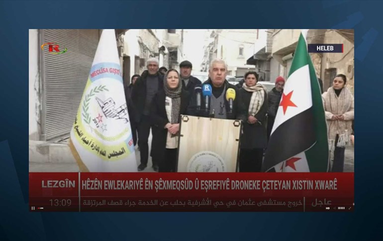 Nouri Sheikho (right) and Hevin Sulaiman (left), co-chairs of the civilian council administering both Sheikh Maqsood and Ashrafiyeh neighborhoods, speak at a press conference in Sheikh Maqsood, Aleppo, on January 7, 2025. Photo: Screengrab/Ronahi TV