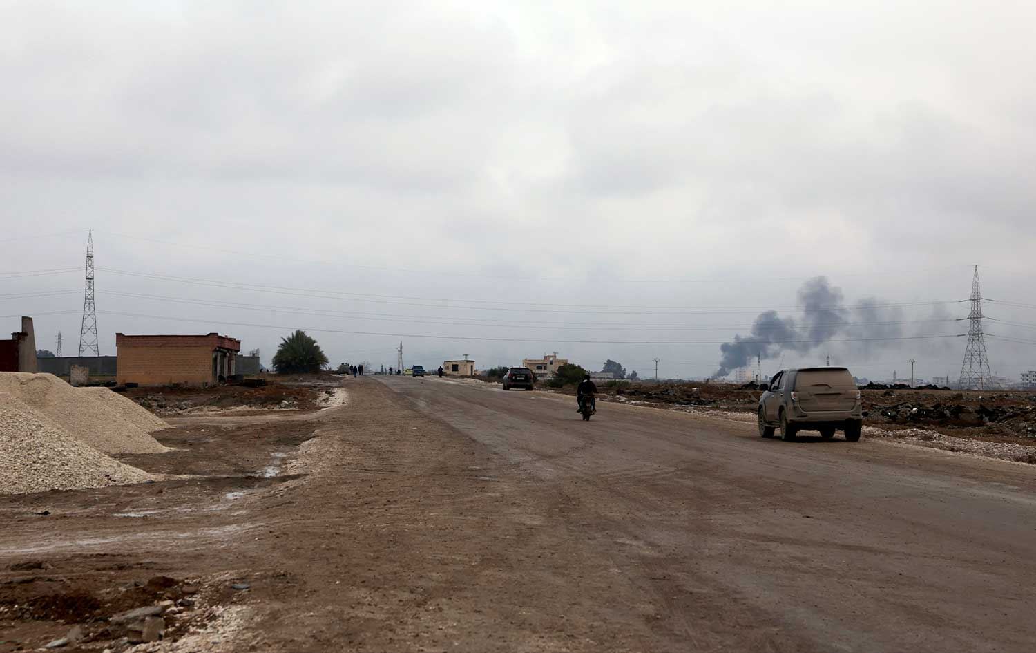 A car and motor bike drive along a road leading to-and-from the northern city of Raqqa on January 18, 2026. File photo: AFP