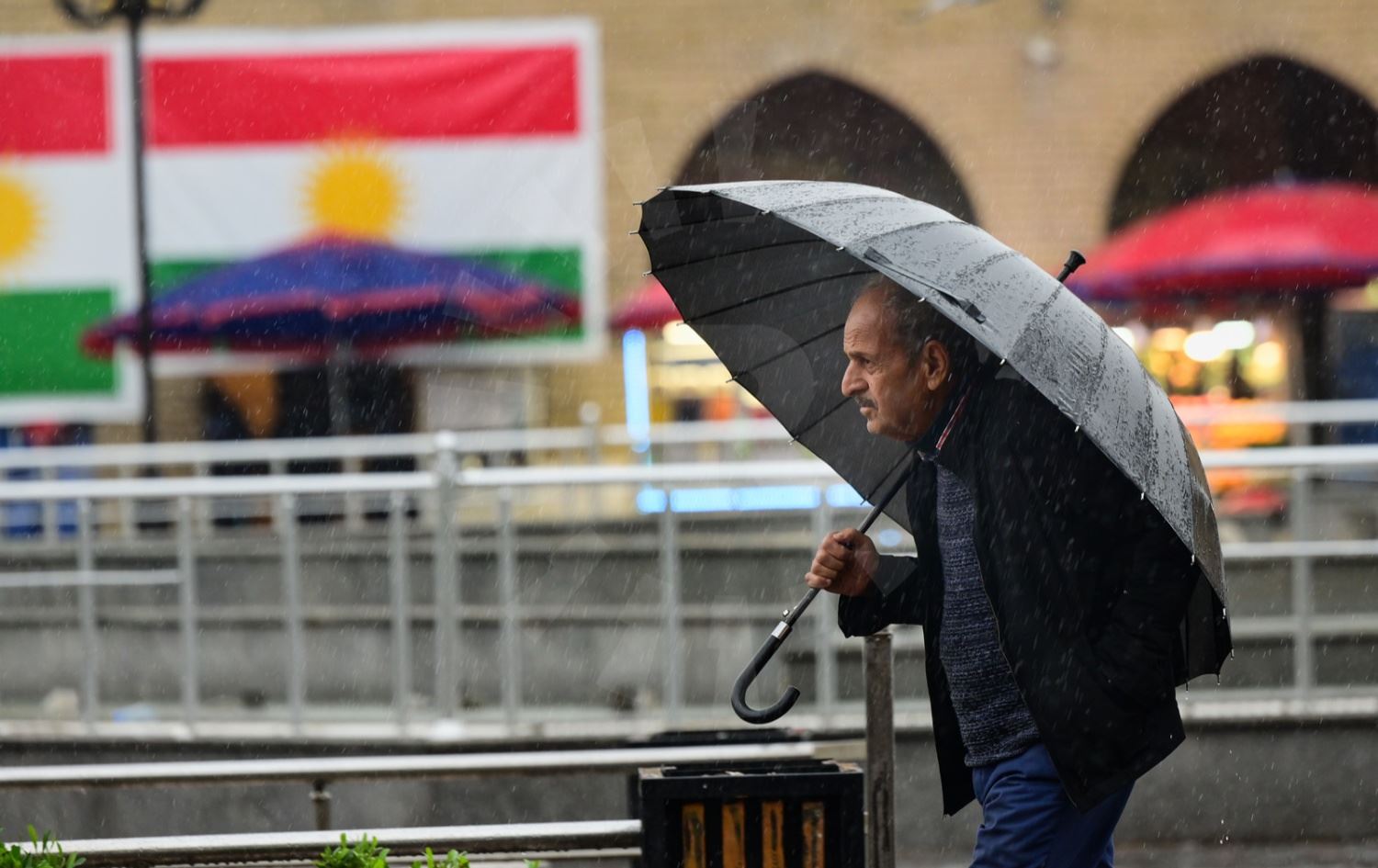 رجل يحمل مظلة في أربيل - تصوير بلند طاهر - رووداو - ارشيف