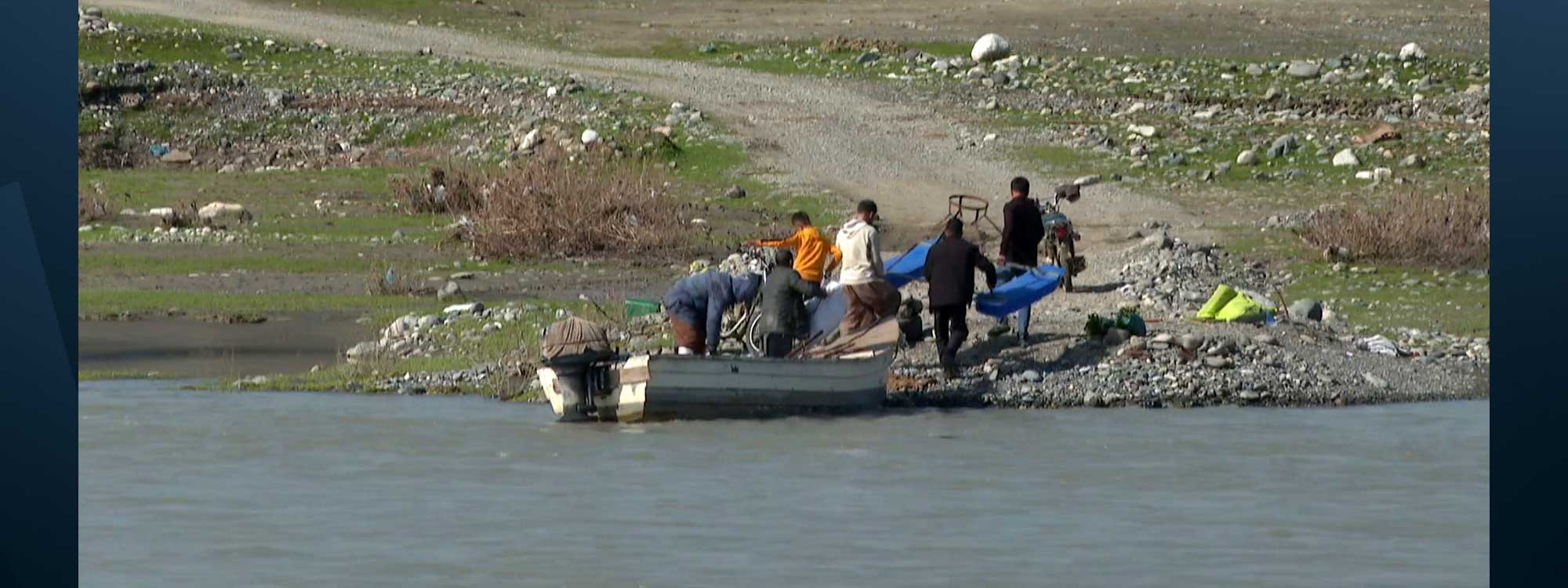 Villagers use a small boat to cross the Little Zab rover in Sulaimani's Pishdar district on February 18, 2026. Photo: Screengrab/ Rudaw