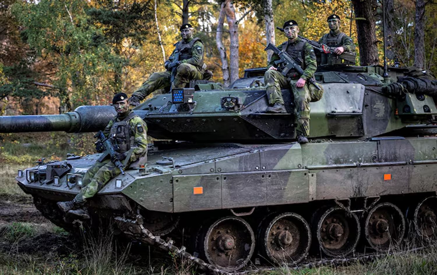 تانکێک و ژمارەیەک سەربازی سوێدی. وێنە: Reuters