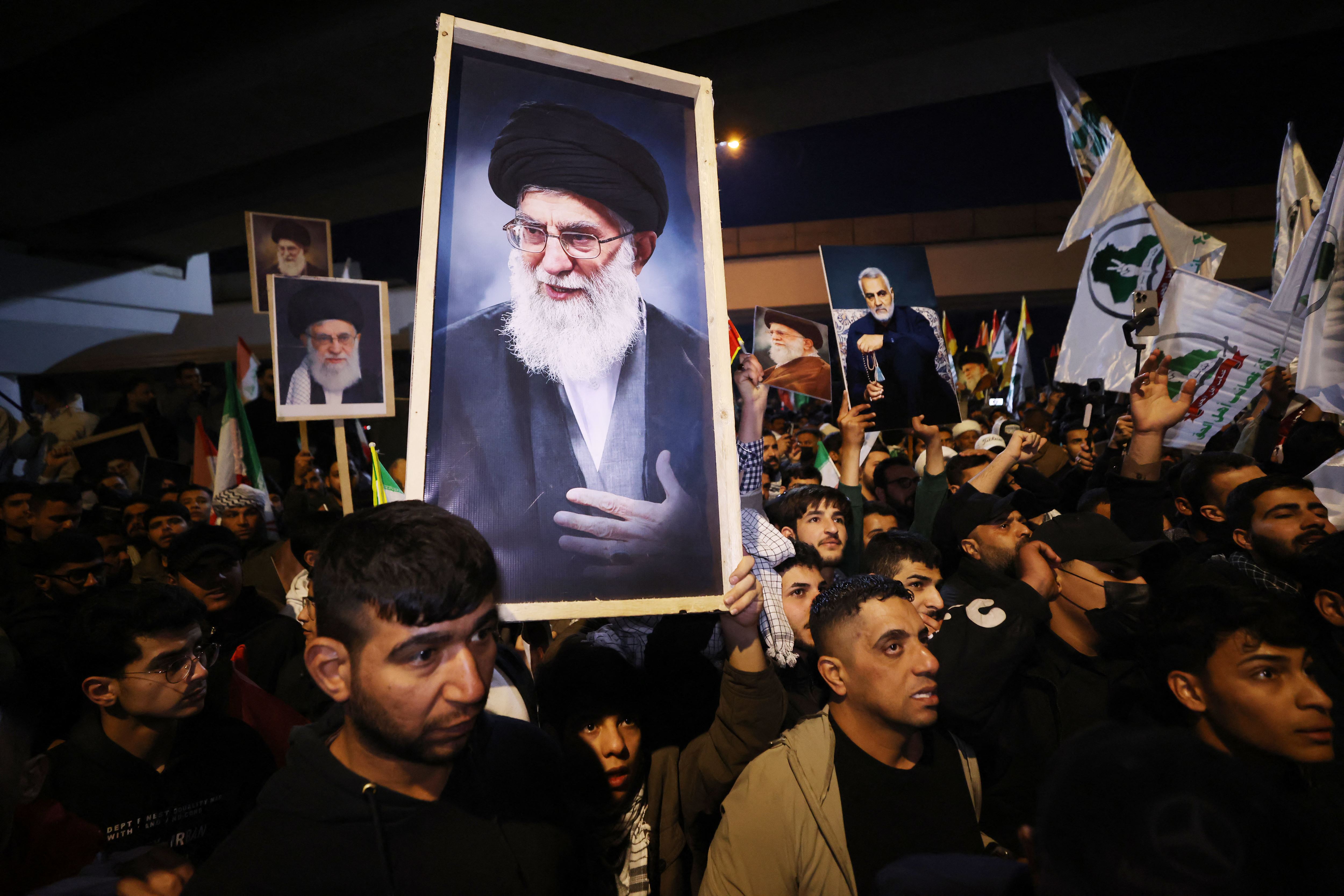 Iraqi Shiites carry a portrait of Iran's Supreme Leader Ayatollah Ali Khamenei during a protest against US and Israeli attacks on Iran at a bridge leading to Green Zone where the US embassy is located, in Baghdad on February 28, 2026. Photo: AFP