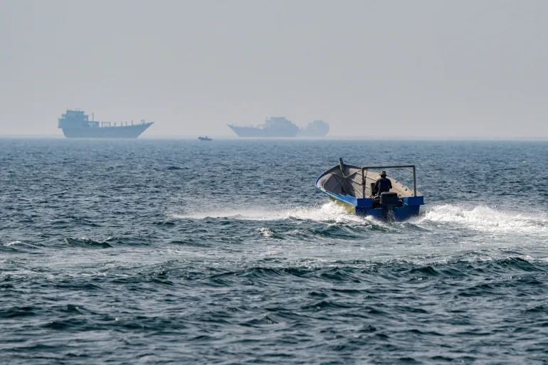 A boat sails in the waters of the Strait of Hormuz off Khasab in Oman's northern Musandam peninsula in June 2025 AFP file photo